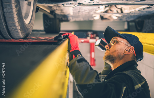 Car Mechanic Spotting Vehicle Suspension Problems