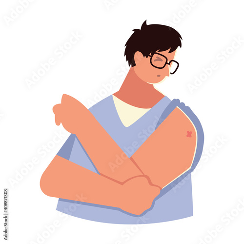 man looks his arm after getting a vaccine
