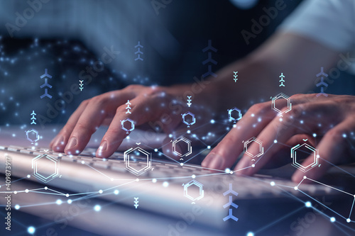 Hands typing the keyboard to create innovative software to change the world and provide a completely new service. Close up shot. Hologram tech graphs. Concept of Dev team.