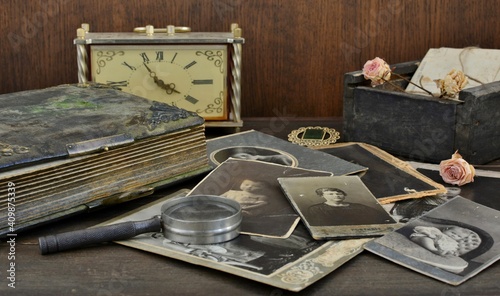  Old photo album and historical photos of family on wooden background,
