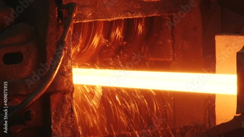 red hot metal bars in continuous casting machine at metallurgical plant