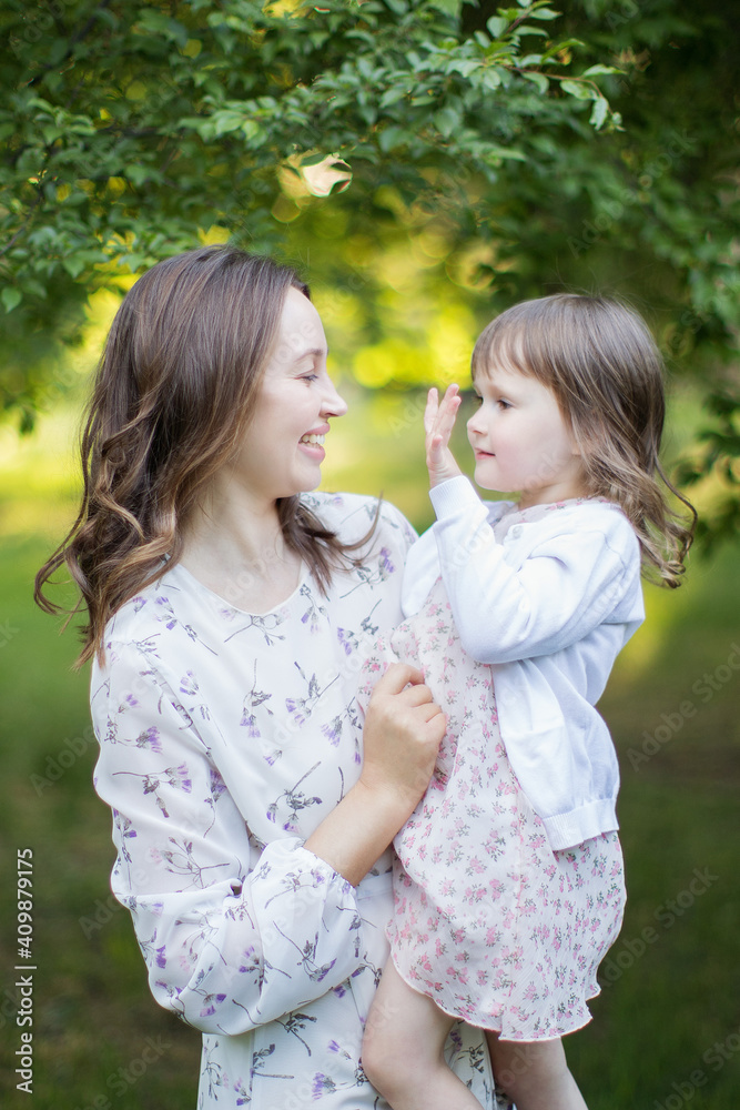 Happy young mother with daughter outdoors. Happy young mother with daughter outdoors.