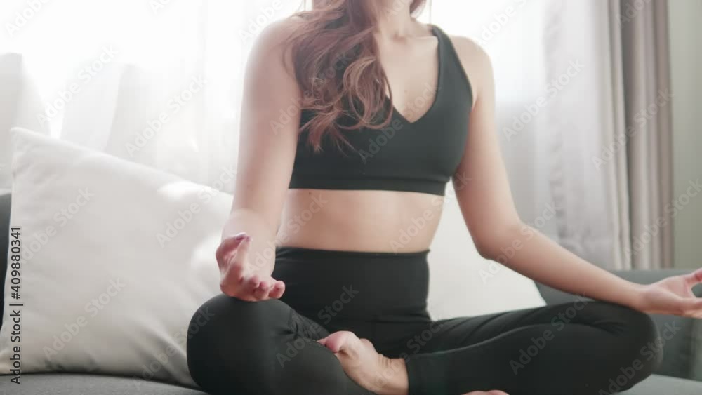 Young Asian women lovey with yoga exercise and stretching in the living room Young Asian women lovey with yoga exercise and stretching in the living room