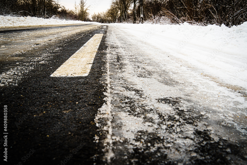Road for traffic in winter, road markings under snow Road for traffic in winter, road markings under snow