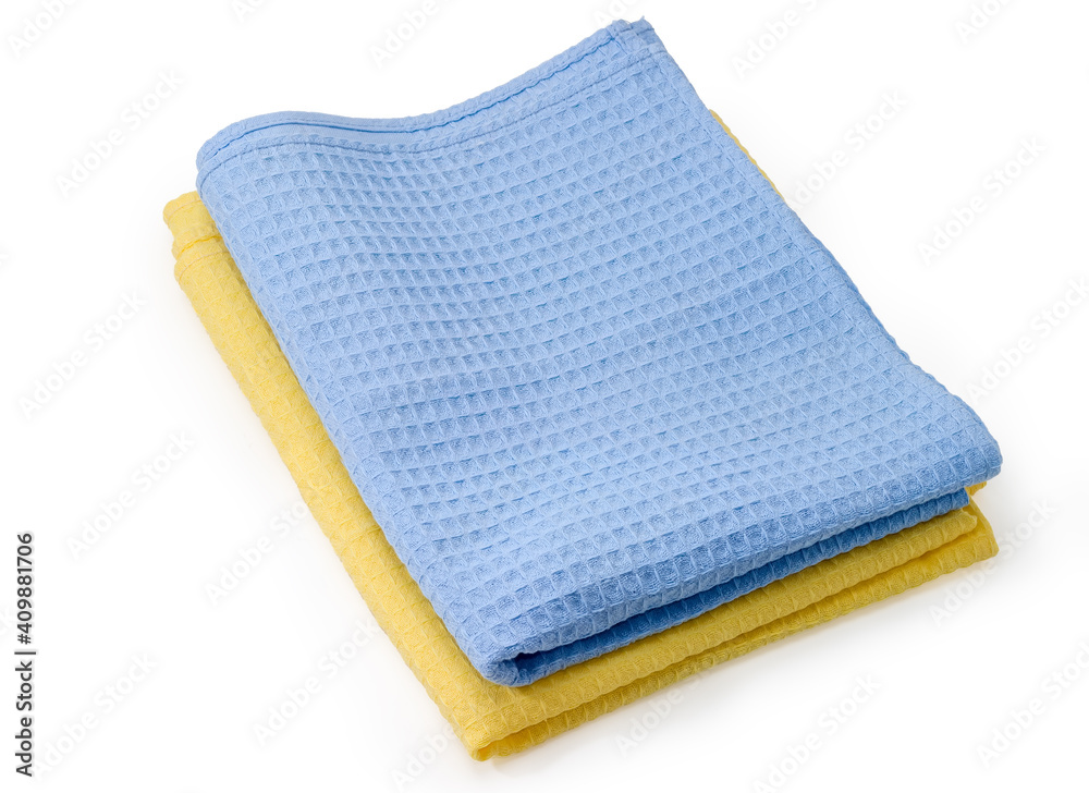 Folded blue and yellow waffle towels on a white background Folded blue and yellow waffle towels on a white background