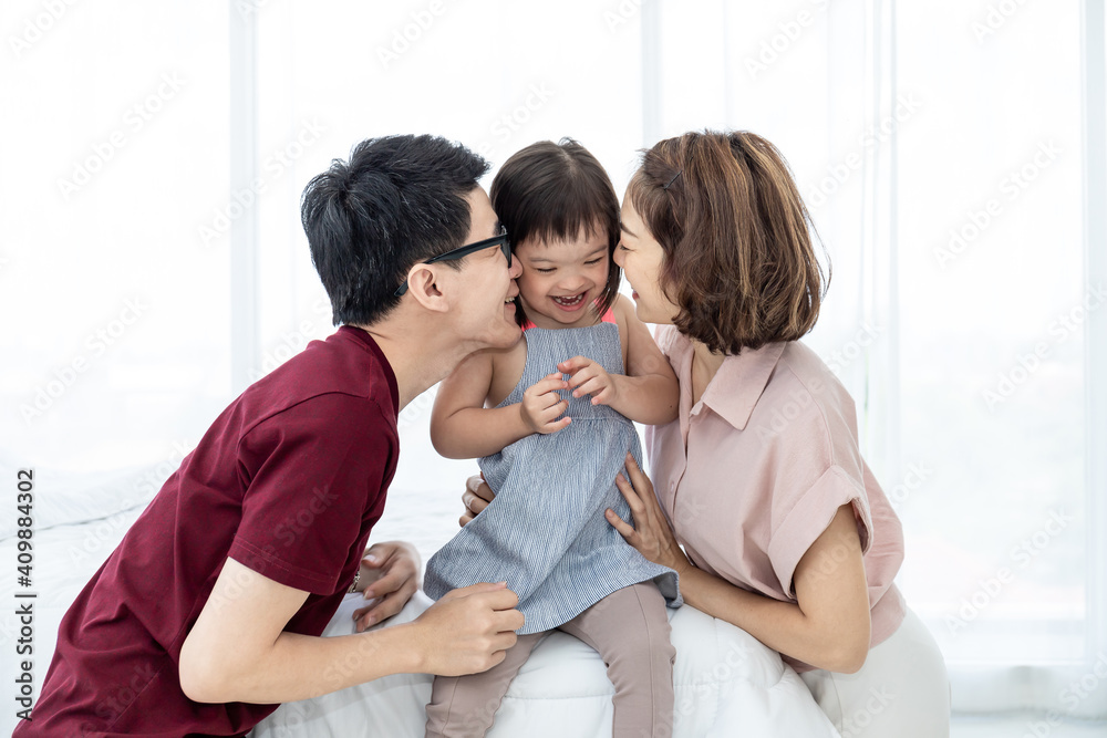 Girls with disabled disorders Learning of the brain Down syndrome constellations Laughing, merry, playing with her parents in the white bedroom bed. Happily Educational concept.