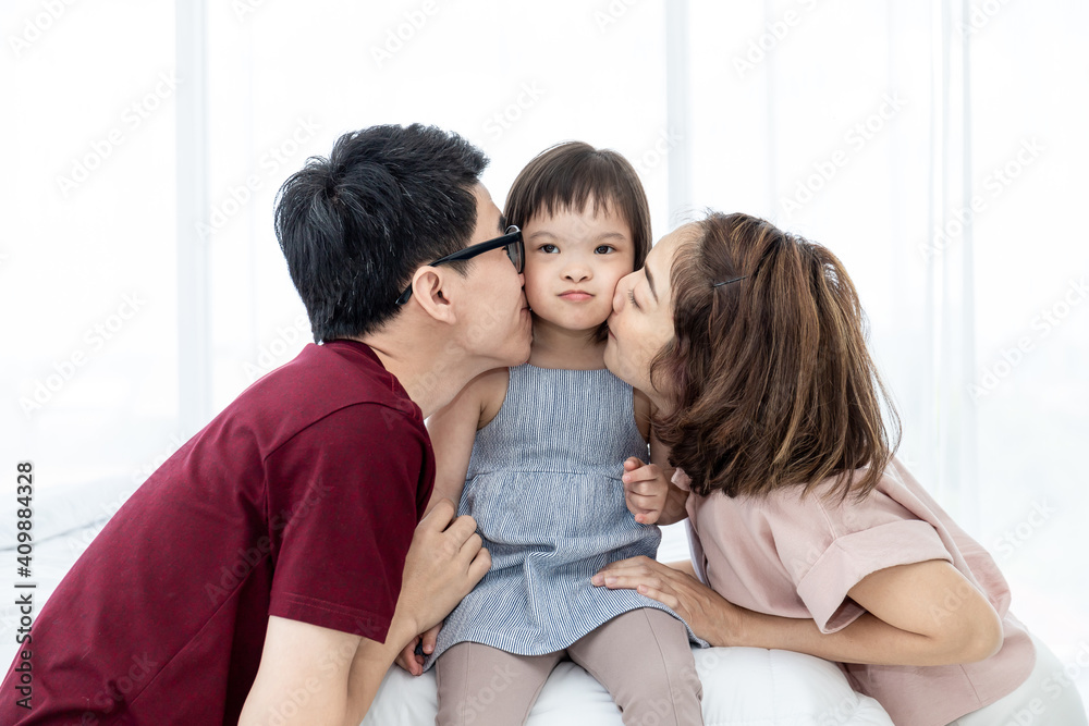 Girls with disabled disorders Learning of the brain Down syndrome constellations Laughing, merry, playing with her parents in the white bedroom bed. Happily Educational concept. Girls with disabled disorders Learning of the brain Down syndrome constellations Laughing, merry, playing with her parents in the white bedroom bed. Happily Educational concept.