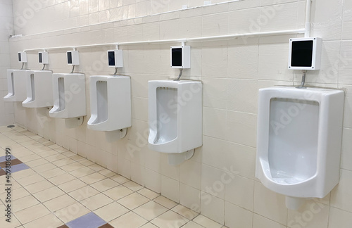 Men s white urinals design  Close up row of outdoor urinals men public toilet  Expulsion from the body  Urinals for men  Urinal concept.