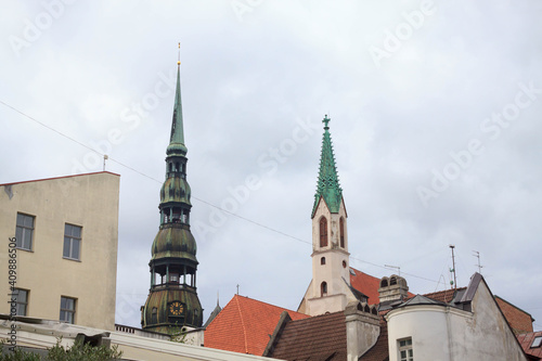 Famous view on latvian highest unique medieval and gothic architecture churches towers and the roofs of old houses on street in the center of capital old city Riga, Latvia, the Baltics region 