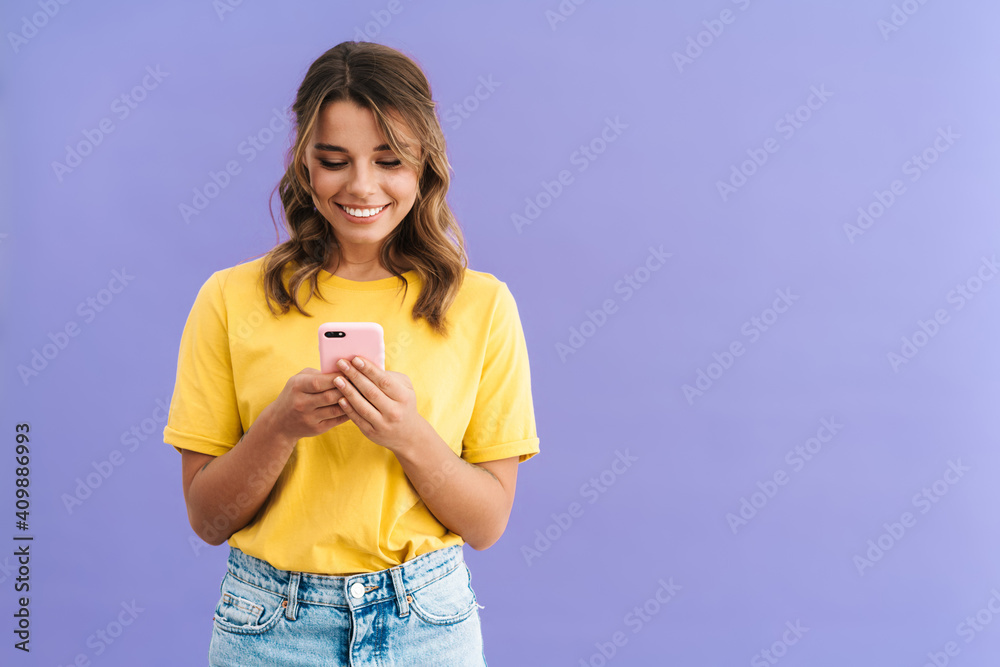 © Drobot Dean - Happy beautiful girl smiling while using mobile phone © Drobot Dean - Happy beautiful girl smiling while using mobile phone
