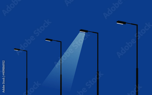 modern light poles/lamp stands on dark blue sky background, street lamps with the light spots, vector illustration, only one spot is lighting