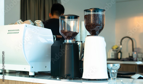 Cafe coffee shop bar and counter with coffee equipment: espresso coffee machine, coffee grinder, cups for drink preparation 
