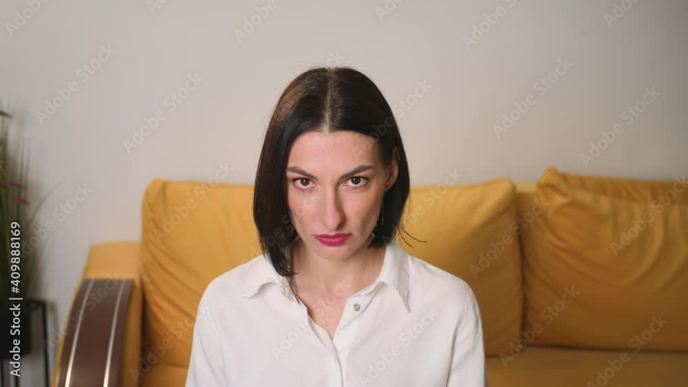 Portrait of confident young attractive businesswoman looking at camera serious successful beautiful at home office close up slow motion Portrait of confident young attractive businesswoman looking at camera serious successful beautiful at home office close up slow motion