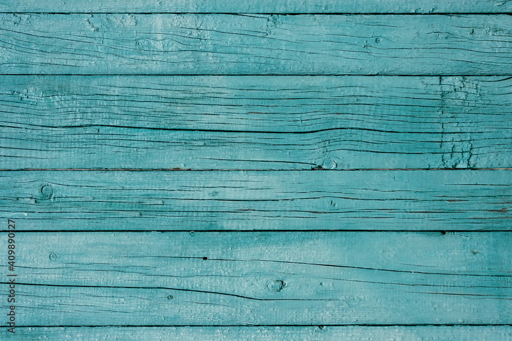 Wooden background. Old blue painted fence in good condition. Solid wooden wall from weathered cracked boards. Barn wood wall. Wooden background. Old blue painted fence in good condition. Solid wooden wall from weathered cracked boards. Barn wood wall.