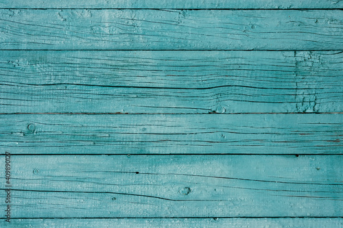 Wooden background. Old blue painted fence in good condition. Solid wooden wall from weathered cracked boards. Barn wood wall.