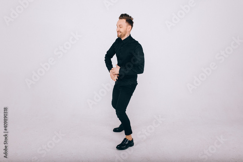 Happy young man dancing over white background