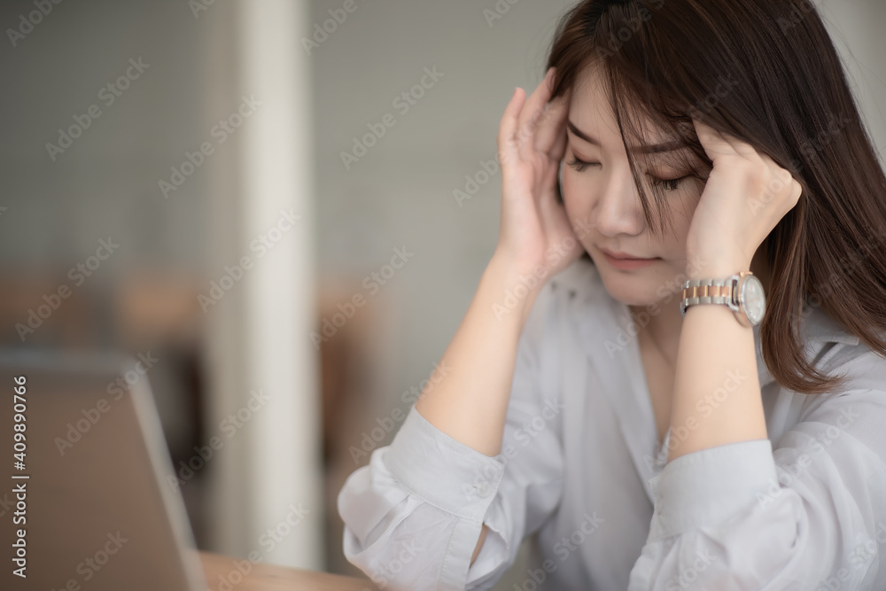 Asian businesswoman gets stressed while having a problem at work in the office. Asian businesswoman gets stressed while having a problem at work in the office.
