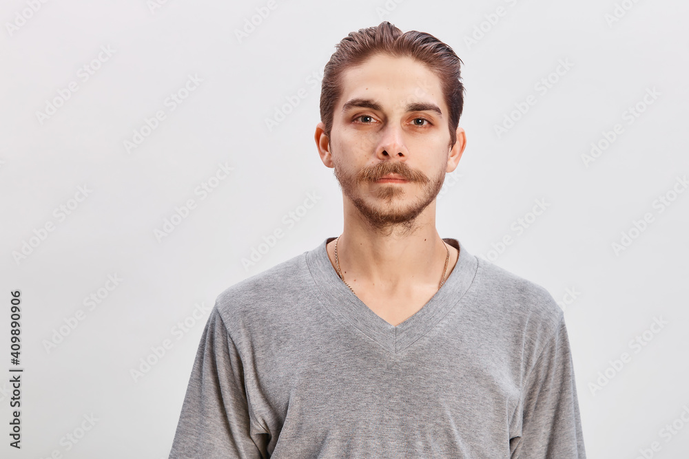 People concept - bearded face man. Friendly young man in gray shirt look in to the camera over grey background. Copy space - obrazy, fototapety, plakaty 