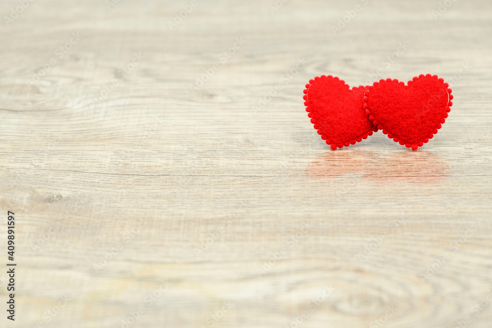Fototapeta premium Two red love heart on wood texture background