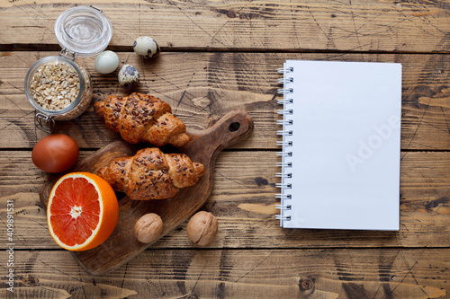 Cood food concept with healthy organic food: bakery, grapefruit, nuts, eggs, top view photo