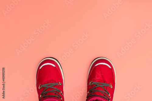 Kids or teenage pink winter boots isolated on pink background. Winter boots for girls. Top view banner