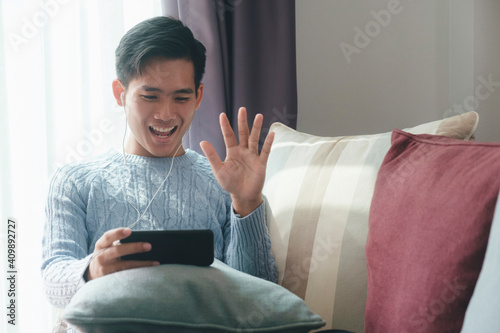 Young man using mobile device for video call. photo