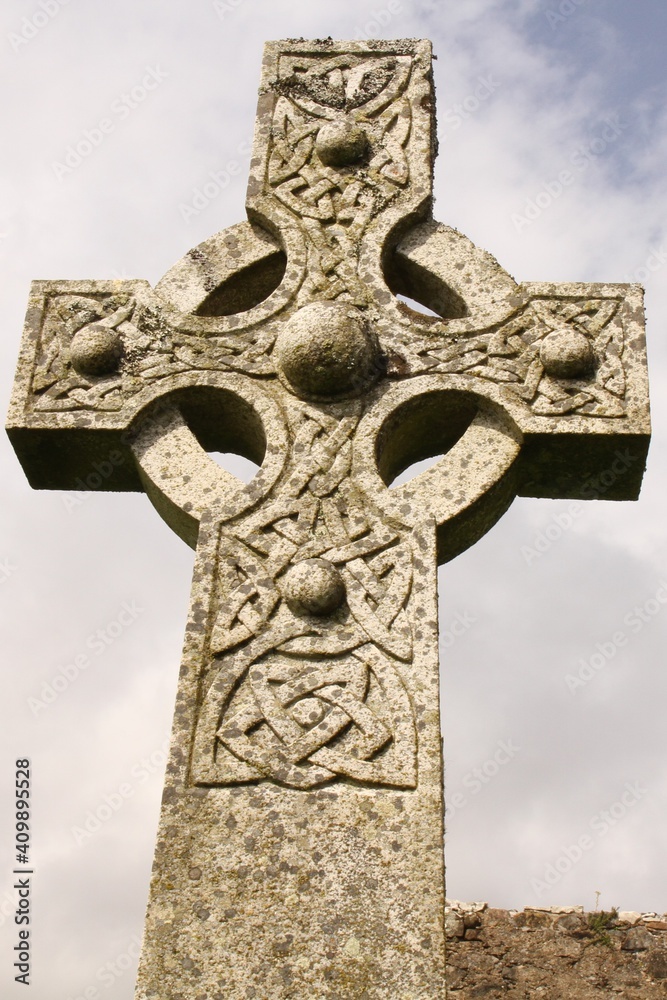 An Ornate Celtic Cross with Knotwork Pattern on a Grave in the Yard of a Ruined Church, Isle of Skye, Inner Hebrides, Scotland. An Ornate Celtic Cross with Knotwork Pattern on a Grave in the Yard of a Ruined Church, Isle of Skye, Inner Hebrides, Scotland.