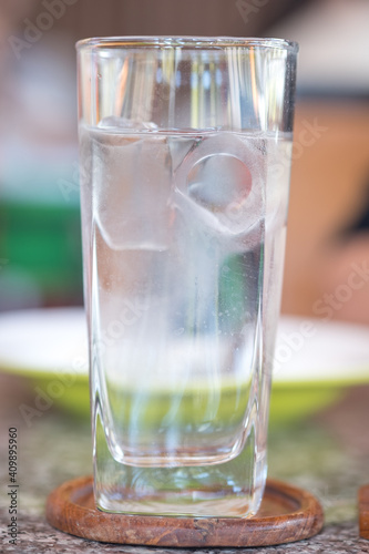 Glass of cold water with ice at restaurant