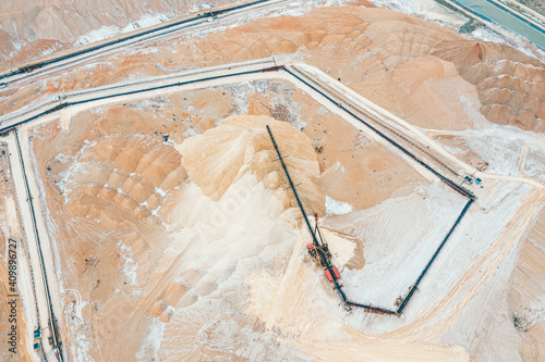 Mountains of salt and a crane upstairs. Extraction of minerals.