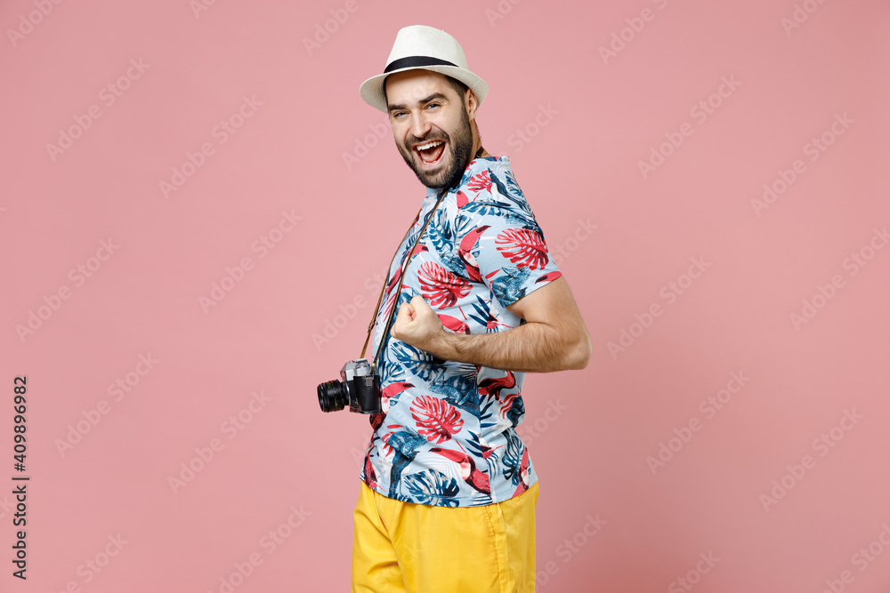 Happy traveler tourist man in hat photo camera doing winner gesture celebrating clenching fists say yes isolated on pink background. Passenger traveling abroad on weekends. Air flight journey concept. Happy traveler tourist man in hat photo camera doing winner gesture celebrating clenching fists say yes isolated on pink background. Passenger traveling abroad on weekends. Air flight journey concept.