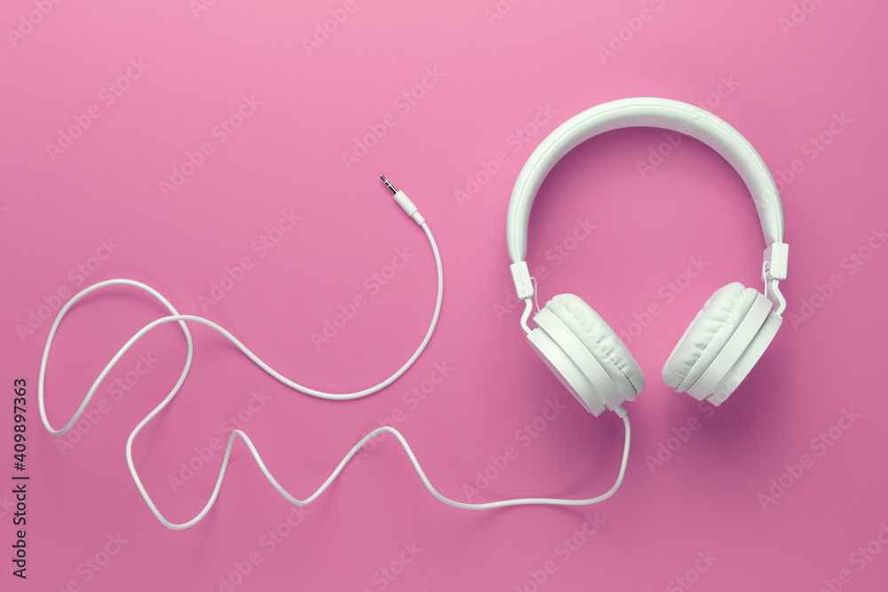 Modern white headphone on pink background. Music concept. Modern white headphone on pink background. Music concept.
