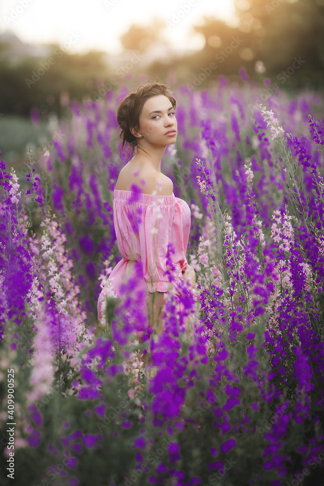 Sexy elegant woman on the meadow of flowers. Beautiful female outdoors. Freedom concept Sexy elegant woman on the meadow of flowers. Beautiful female outdoors. Freedom concept