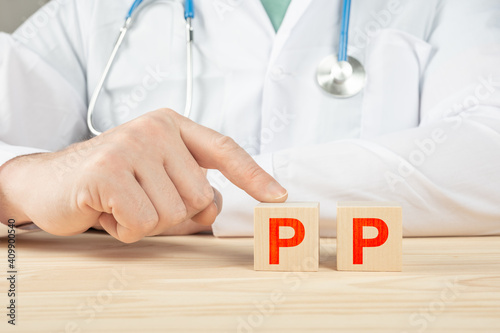 essential vitamins and minerals for humans. PP alphabet on wood cube. doctor recommends taking vitamin PP. doctor talks about the benefits of vitamin PP. PP Vitamin - Health Concept. photo