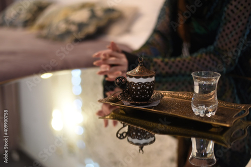 Wallpaper Mural Turkish coffee in a colorful cup on a mirrored table and the figure of an oriental woman in the background. Torontodigital.ca