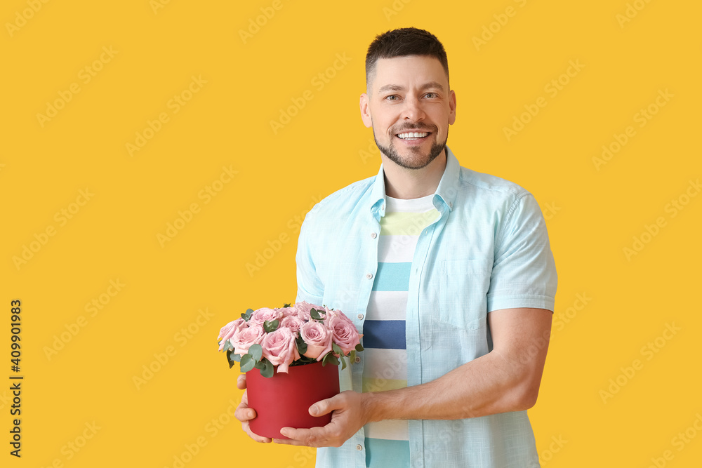 Handsome man with bouquet of beautiful flowers on color background Handsome man with bouquet of beautiful flowers on color background