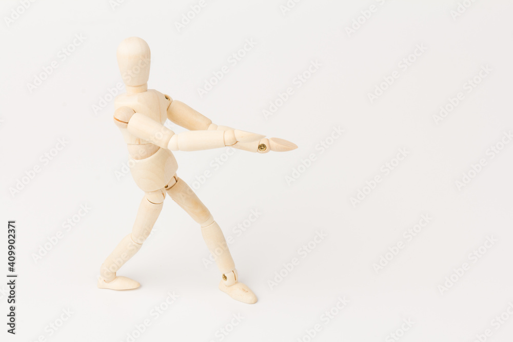 A wooden mannequin isolated against a white background A wooden mannequin isolated against a white background