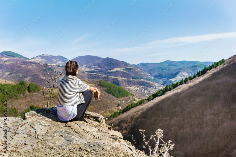 Young Woman Sitting above the  Mountain with Stunning View .Pirin Mountain ,Bulgaria   
