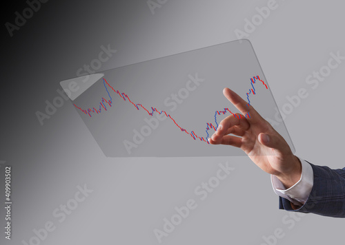 Business man toucing screen and showing holographic graphs and stock market statistics gain profits. Concept of growth planning and business strategy. photo