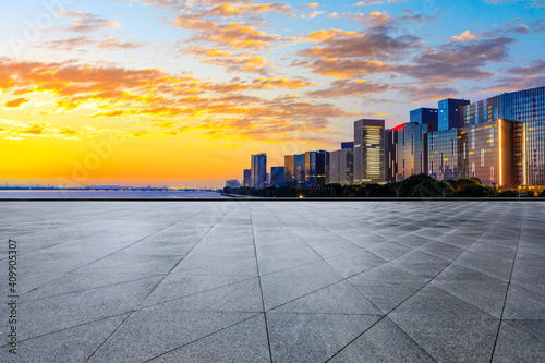 Empty square floor and modern city skyline in Hangzhou at sunrise,China.