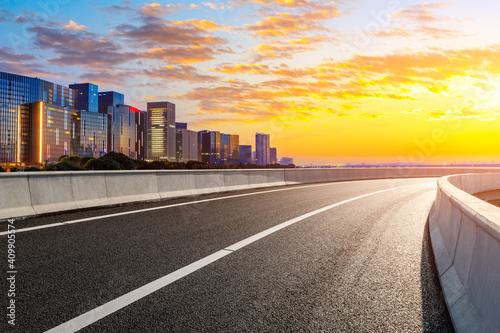 Empty asphalt road and modern city skyline in Hangzhou at sunrise China.