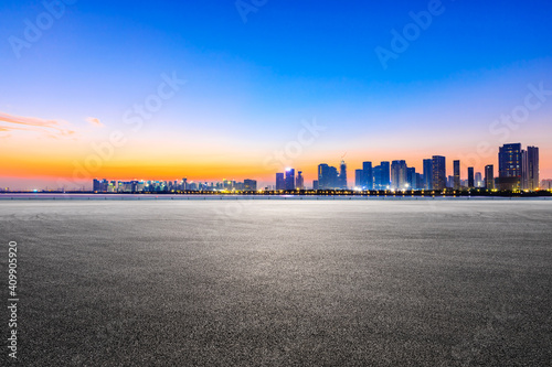 Race track road and Hangzhou skyline with buildings at sunrise.