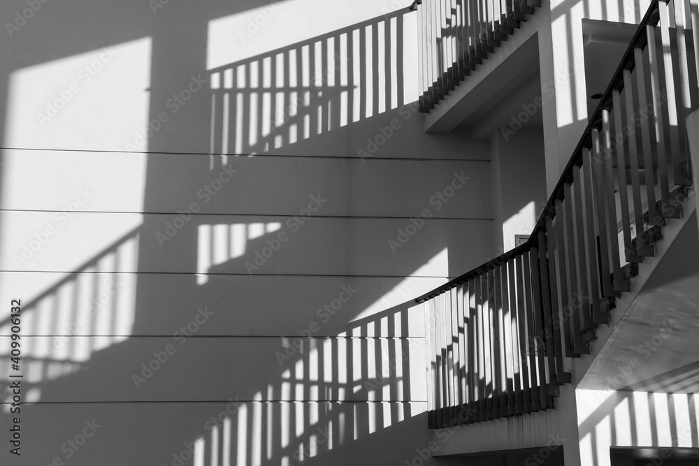 Fototapeta premium Architectural shadows by building stair hitting light