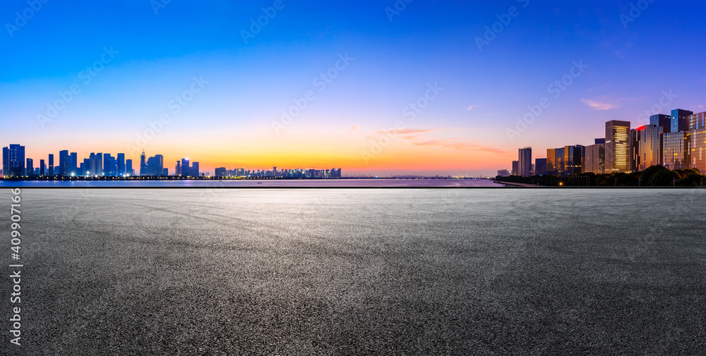 Race track road and Hangzhou skyline with buildings at sunrise.