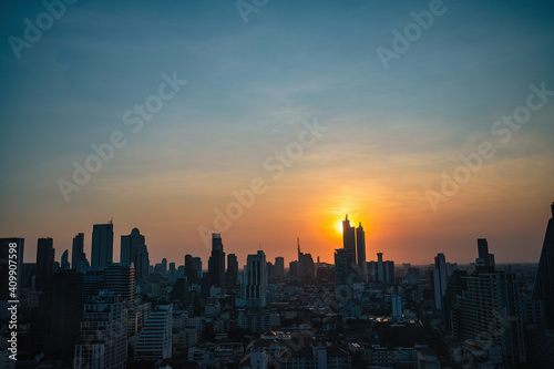Fototapeta Naklejka Na Ścianę i Meble -  Bangkok Cityscape view with beautiful Sunset and silhouette of the building.Bangkok is the capital and most populous city of Thailand.