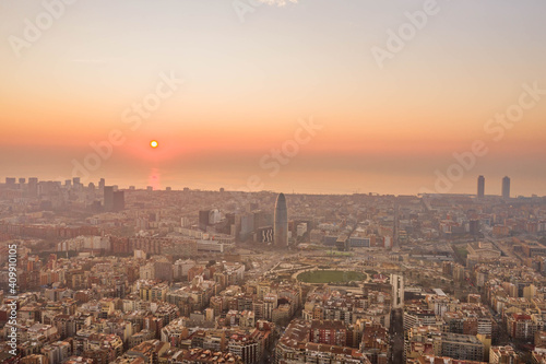 Aerial drone shot of rising sun over Barcelona city beach