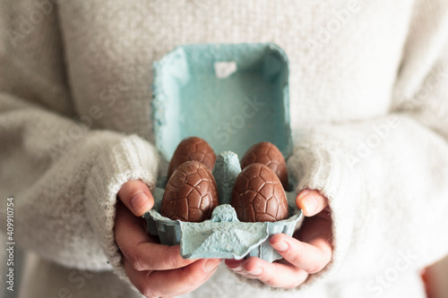 Canvas Print Close up of woman holding carton egg box with easter chocolate eggs