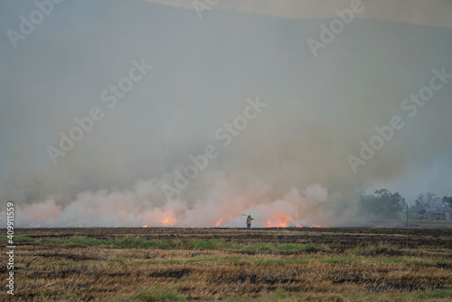 Smoke from burning. Farmers burn rice straw to prepare to plant rice for the next season. Toxic effect resulting from burning of rice straw. © somchai