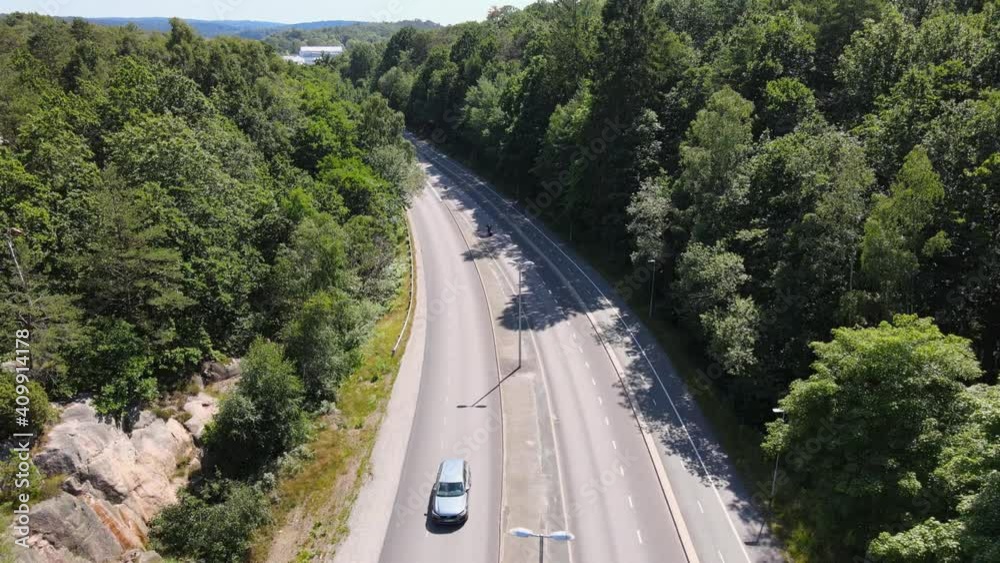 Above aerial view of motorbike accelerating away out of view. Sunny summerday in Gothenburg, Sweden. 4K drone footage. Above aerial view of motorbike accelerating away out of view. Sunny summerday in Gothenburg, Sweden. 4K drone footage.