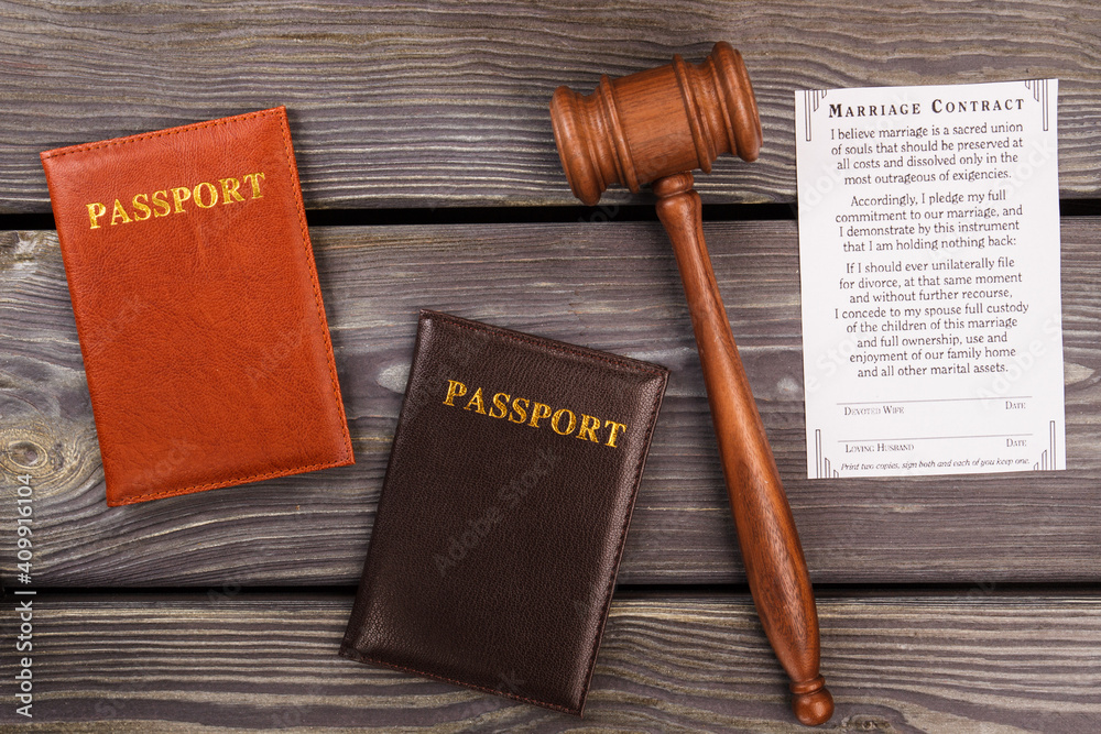 Marriage contract concept. Passports with gavel on wood.