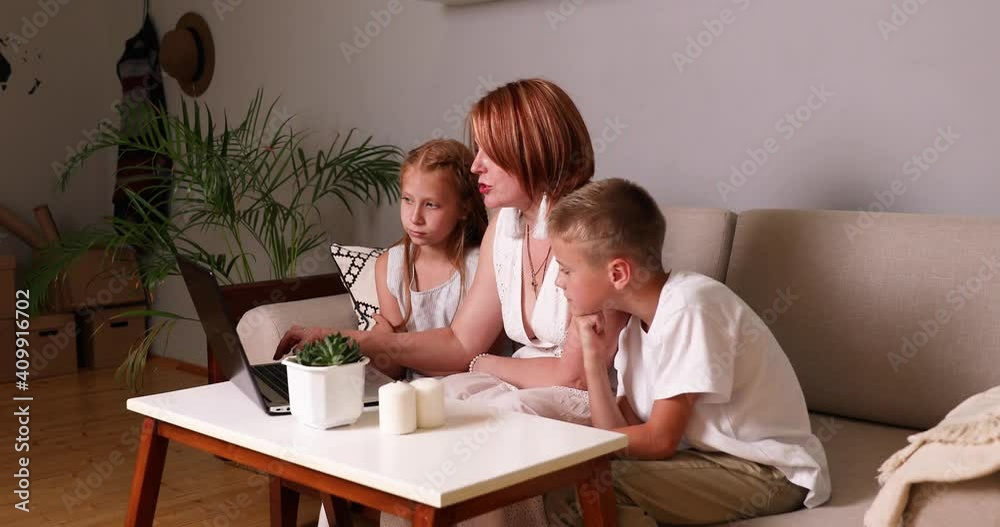Mom explains the lessons to the kids on the laptop. Home Learning Mom explains the lessons to the kids on the laptop. Home Learning